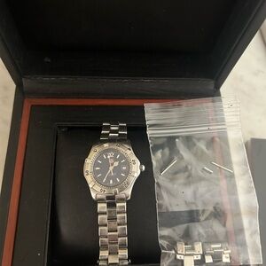 Tag Heuer stainless steel watch with navy blue face. .